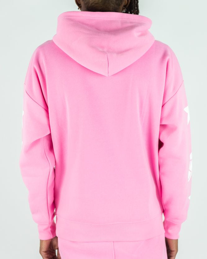 Person wearing a pink onesie with a hood against a white background