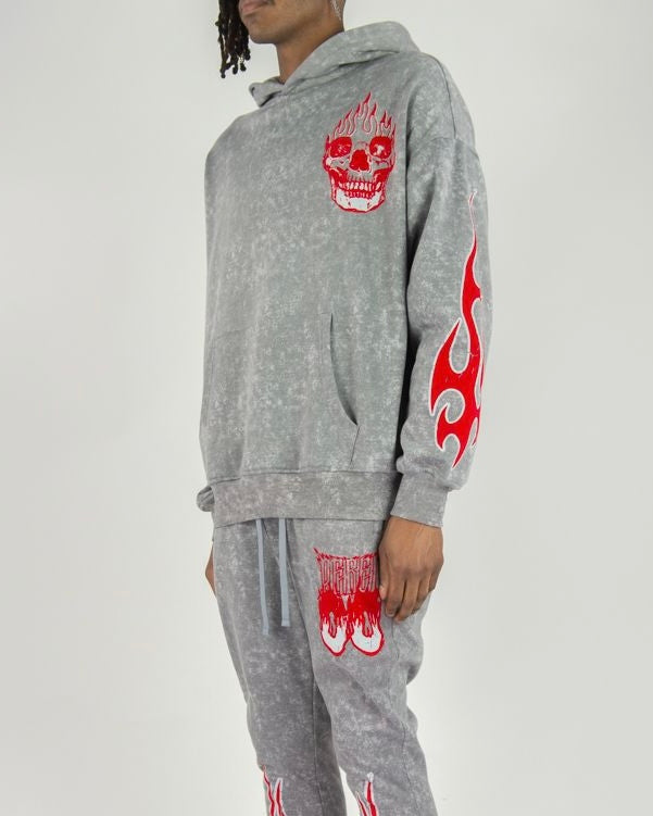 Gray hoodie and pants set with red designs on a white background