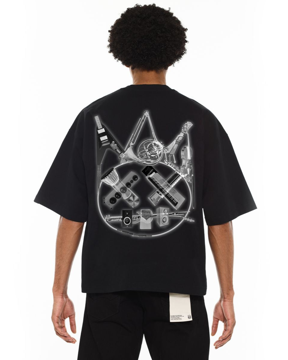 Person wearing a black t-shirt with a graphic design on the back, standing against a white background