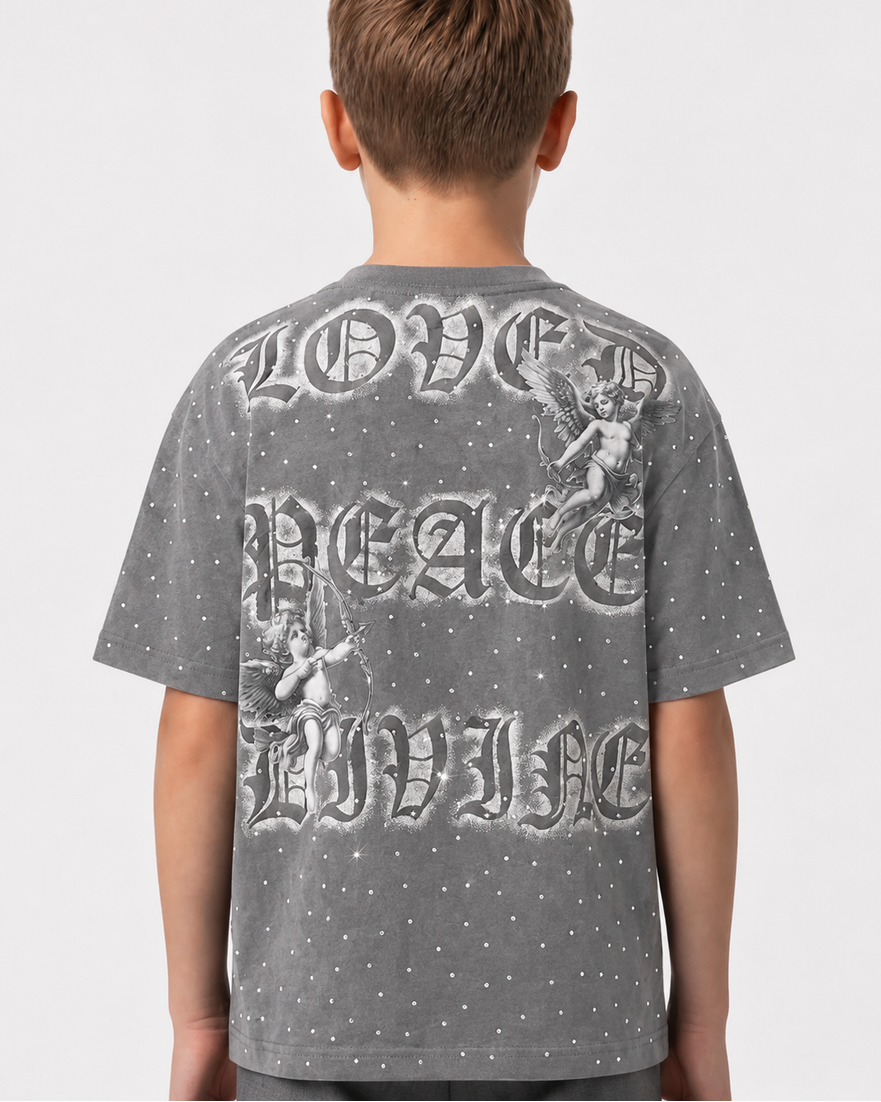 Child wearing a gray t-shirt with 'Love Peace Live' text on the back against a white background