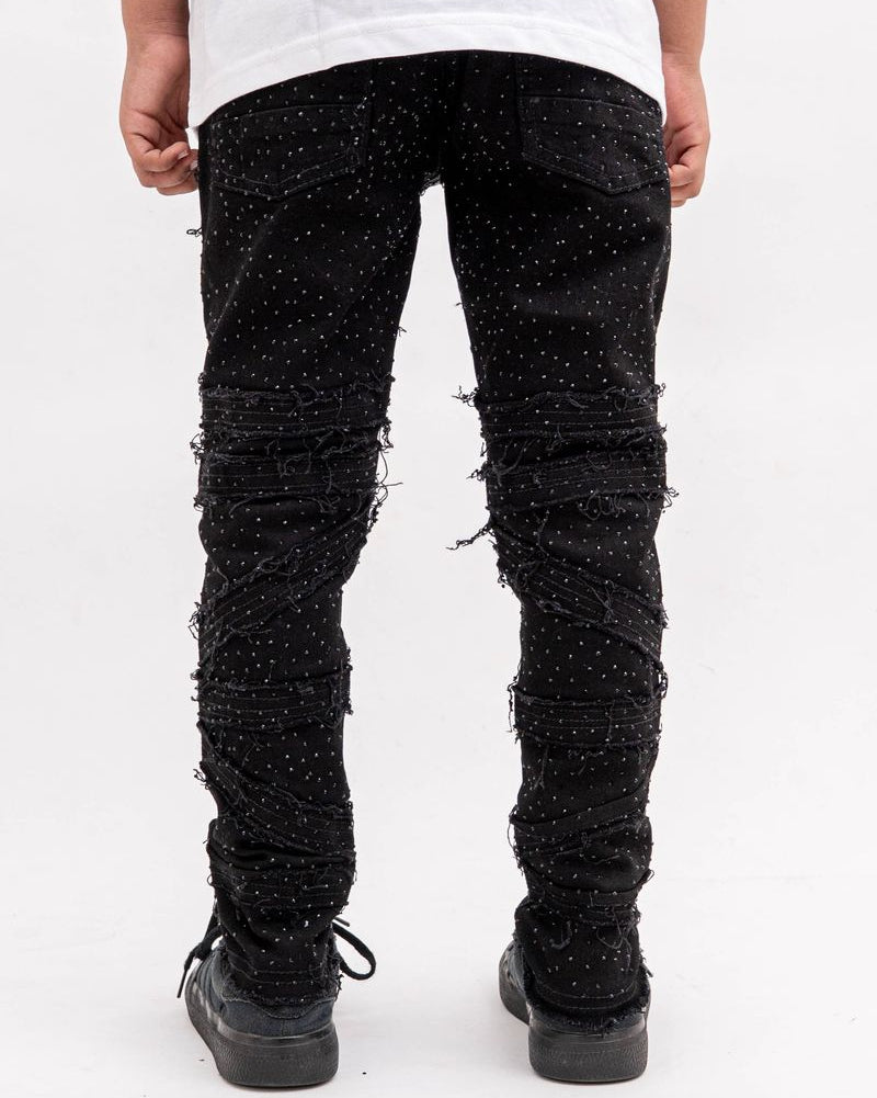 Person wearing black distressed jeans on a white background