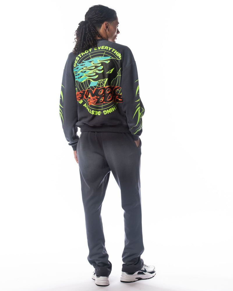 Person wearing a gray tracksuit with colorful graphics on the back against a white background