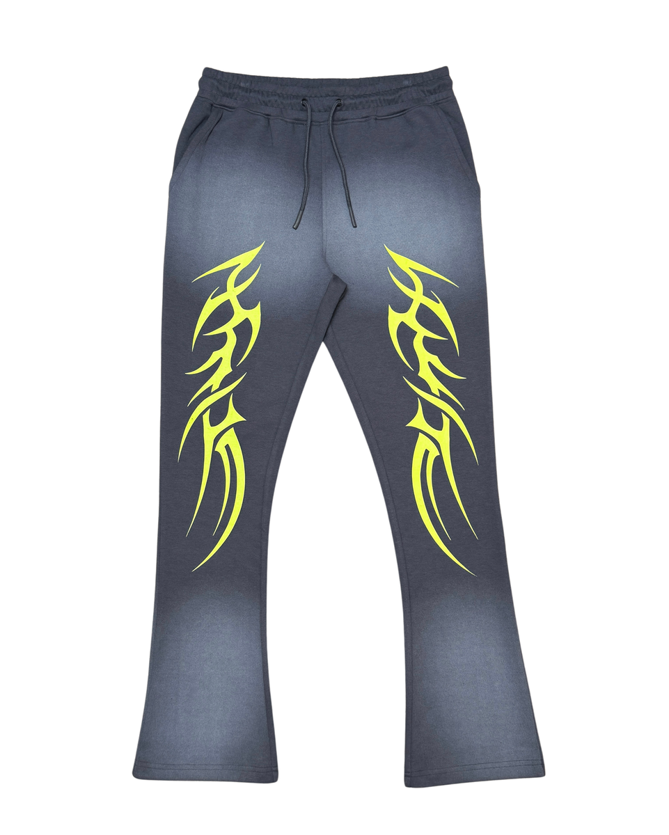 Gray sweatpants with yellow tribal designs on a white background