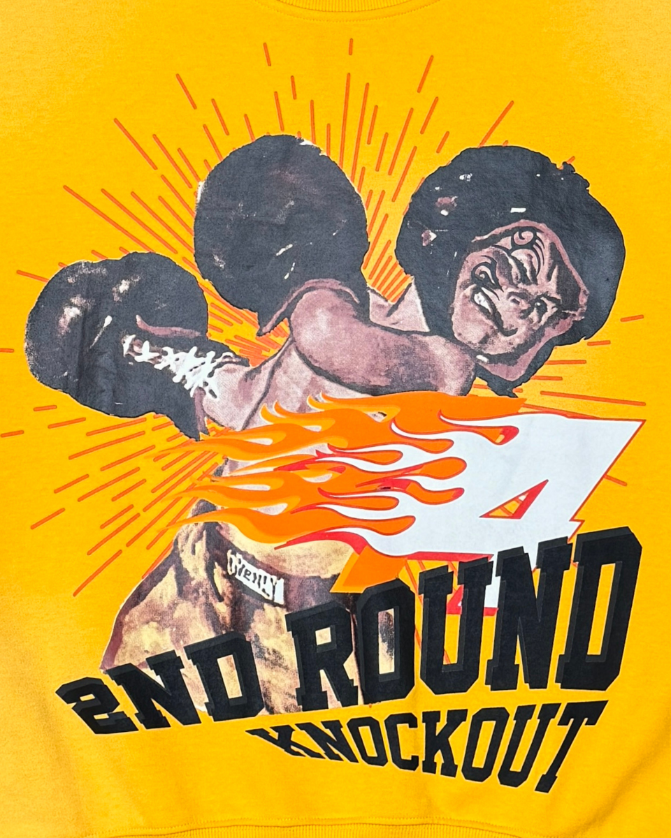 T-shirt with graphic of a boxer and '2nd Round Knockout' text on a yellow background