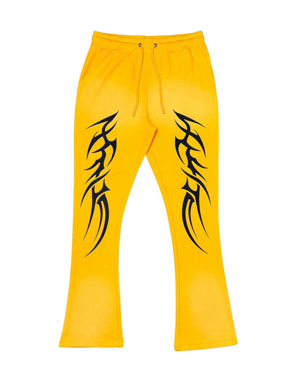 Yellow pants with black tribal designs on a white background