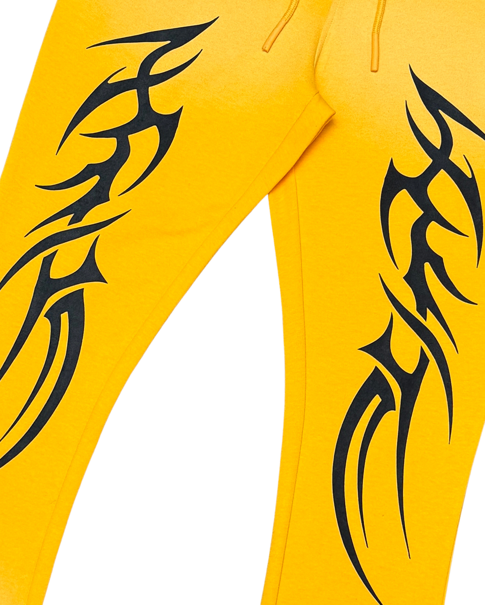 Yellow pants with black tribal designs on a white background