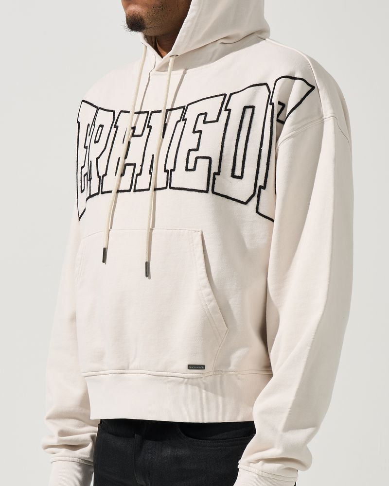 Person wearing a white hoodie with text design on a plain background