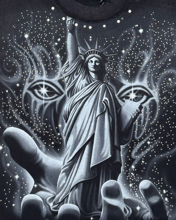 Black t-shirt with a graphic of the Statue of Liberty and mystical elements on a dark background