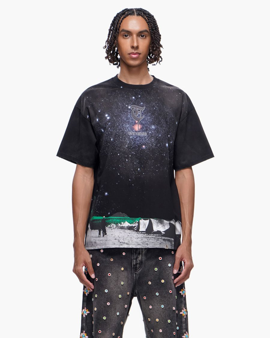 Person wearing a black t-shirt with a graphic design on a white background