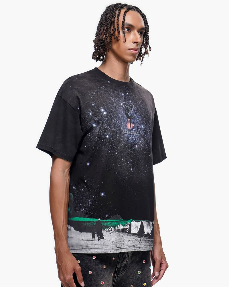 Person wearing a black t-shirt with a graphic design on a white background