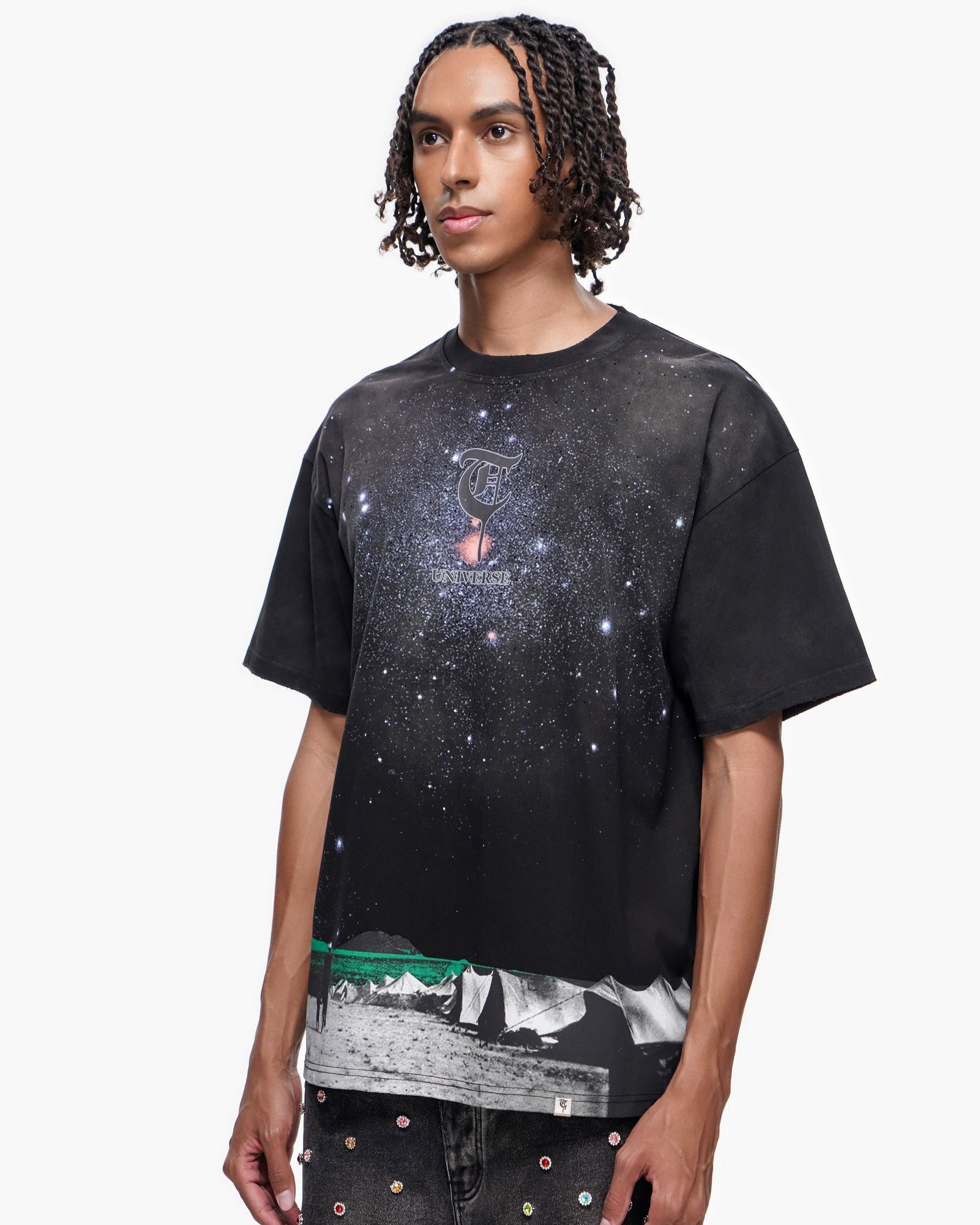 Person wearing a black t-shirt with a graphic design on a white background