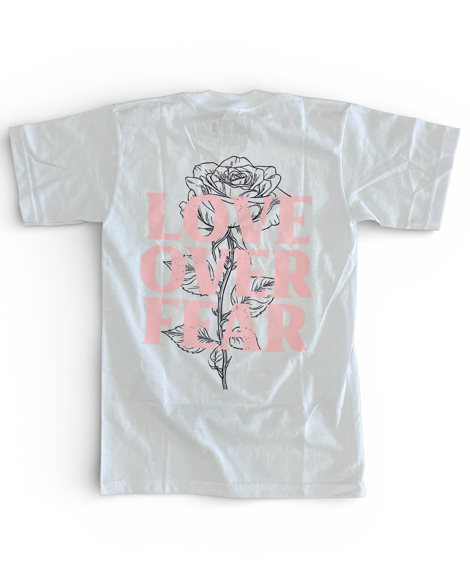 White t-shirt with a rose graphic and 'Love Over Fear' text on a white background