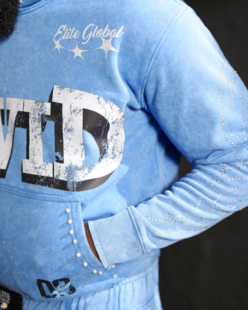 Blue tracksuit with 'ELITE GLOBAL' branding on a dark background