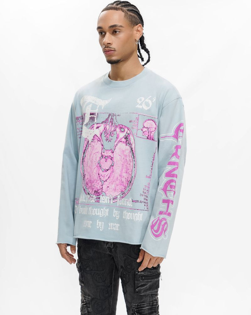 Person wearing a light blue long-sleeve shirt with pink graphic design on a white background