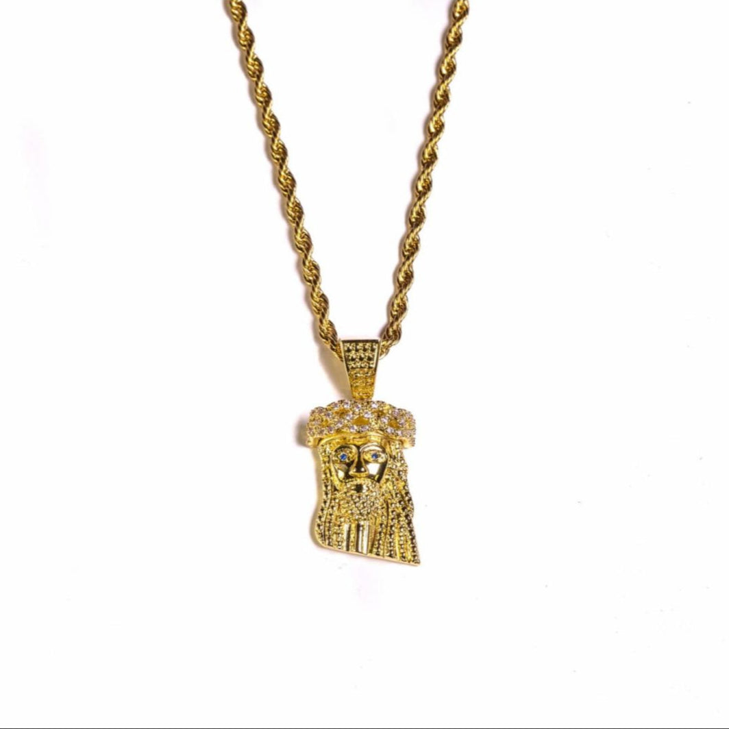 Gold necklace with a detailed mini Jesus pendant on a white background