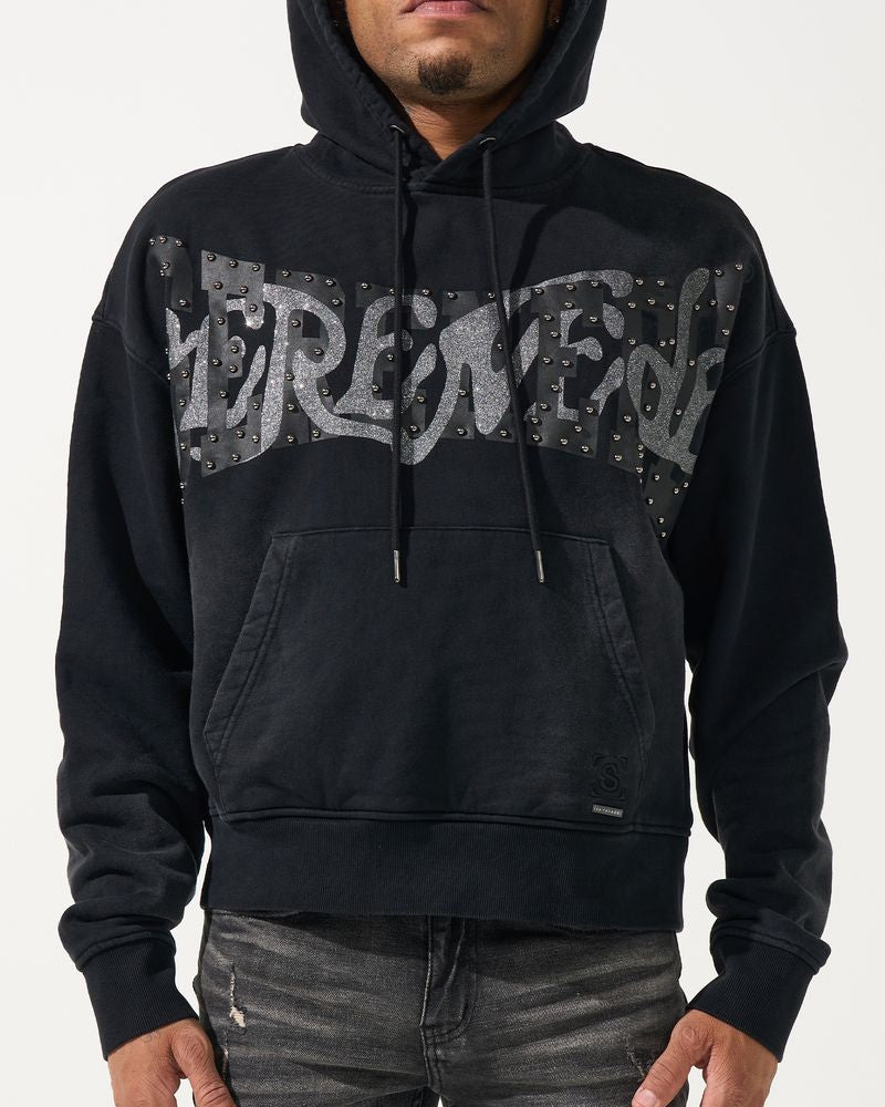 Person wearing a black hoodie with graphic design on a white background