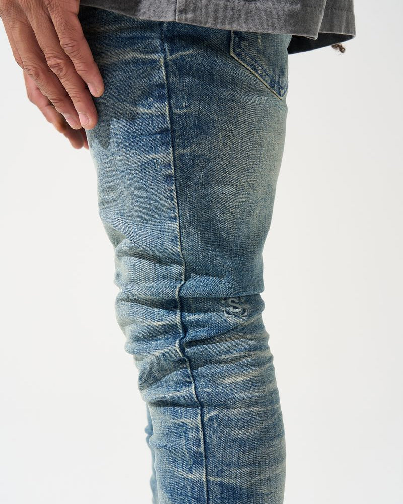Close-up of blue jeans with a white background