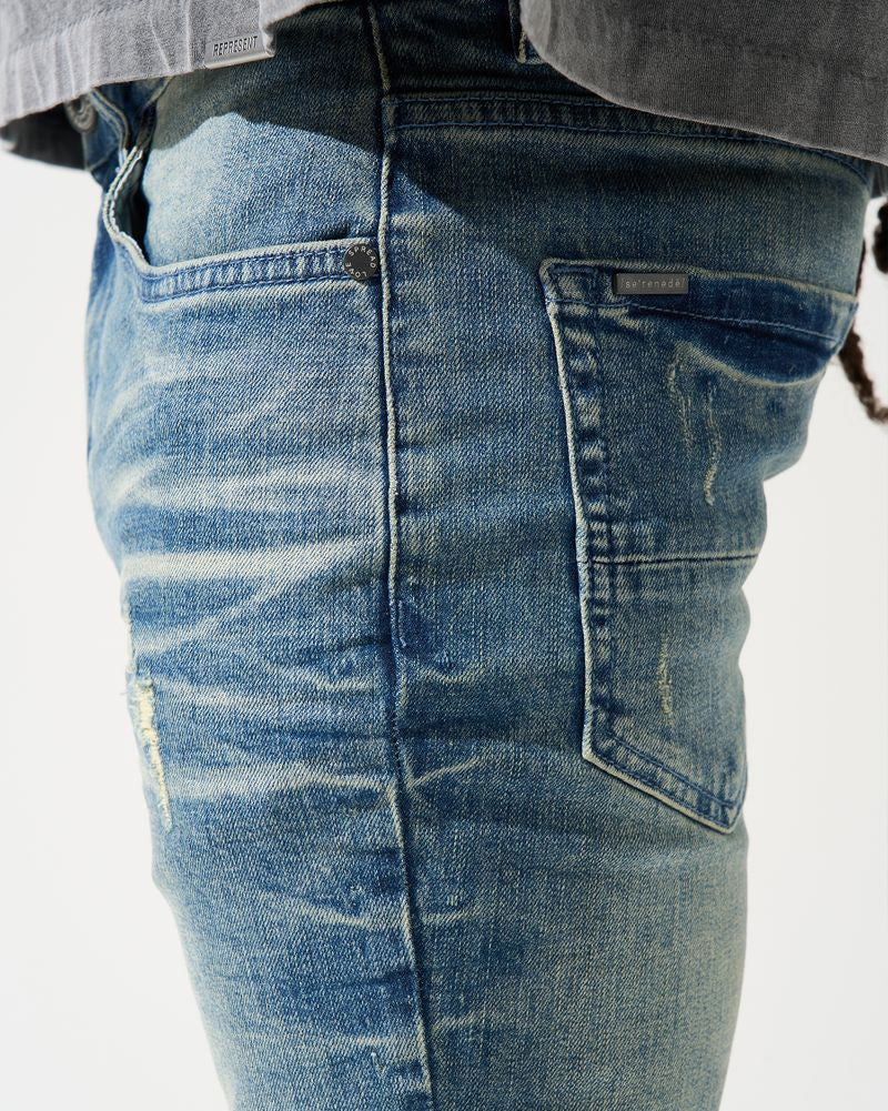 Close-up of blue jeans with a white background