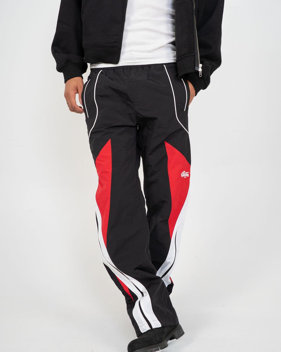 Black and red tracksuit with white accents on a plain background