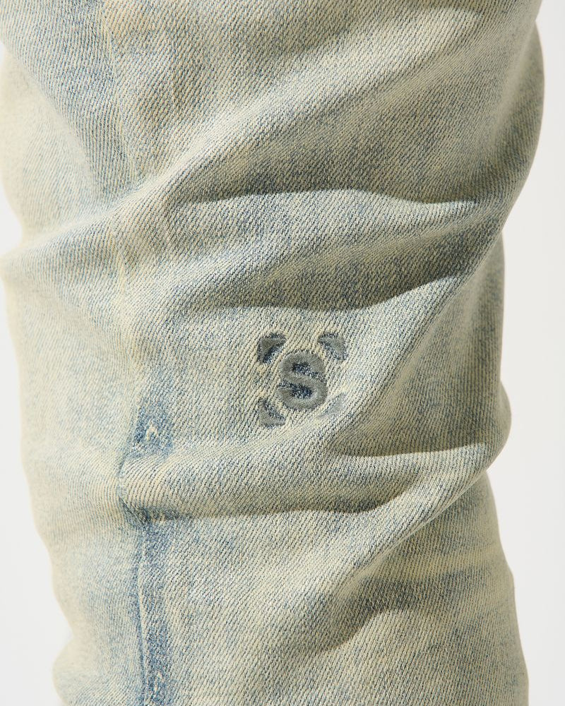 Close-up of a worn denim pocket with visible stitching and fading.