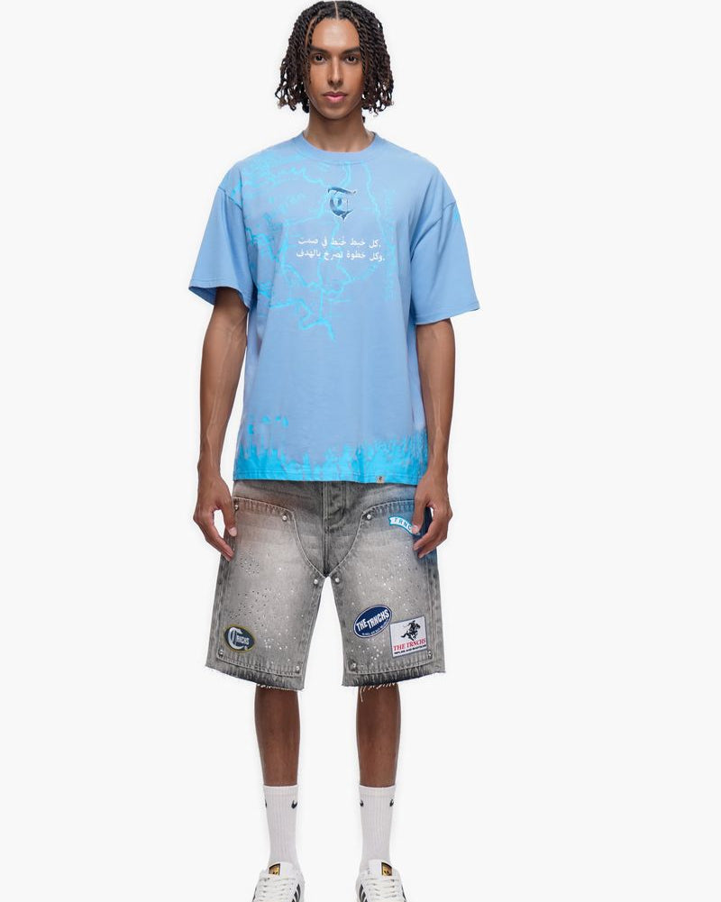 Person wearing a light blue t-shirt and gray shorts on a white background