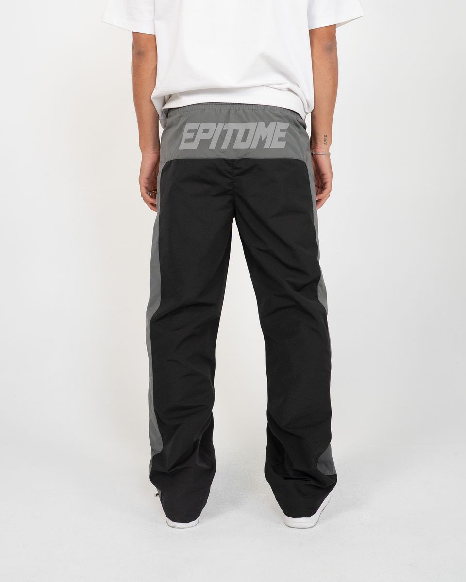 Person wearing black pants with 'Epitome' branding on a white background