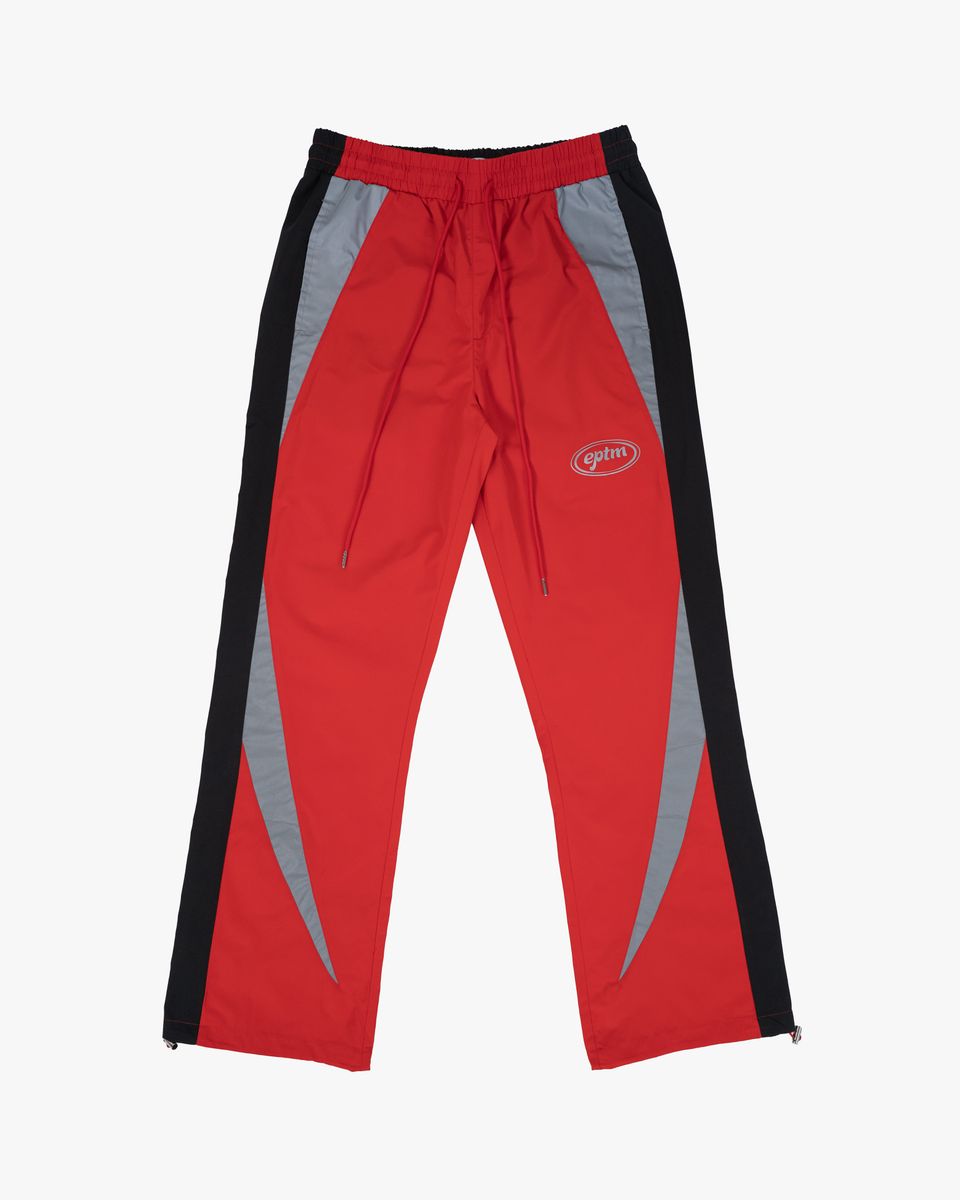 Red track pants with black and gray accents on a white background