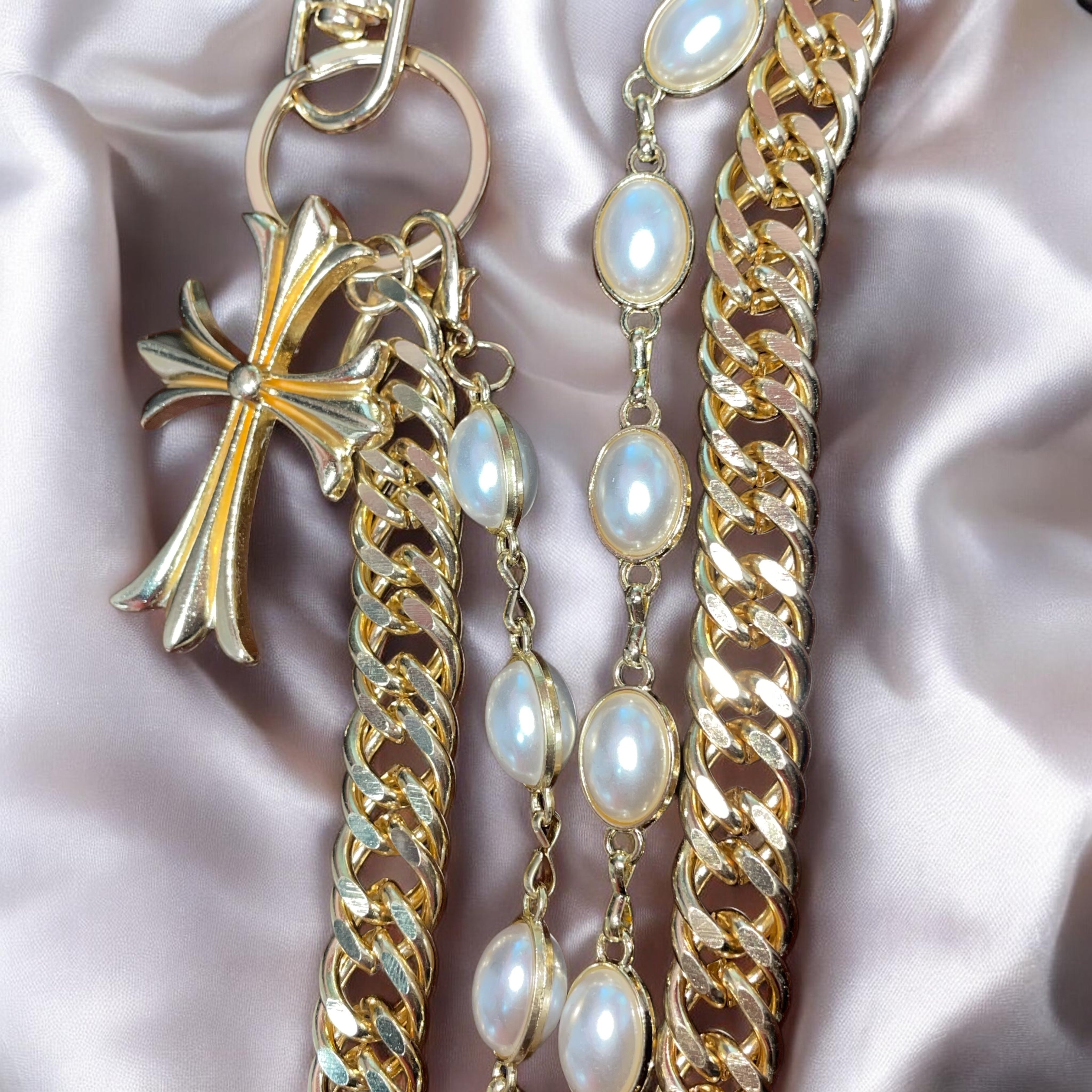 Gold WALLET chain with pearl-like beads on a pink satin background