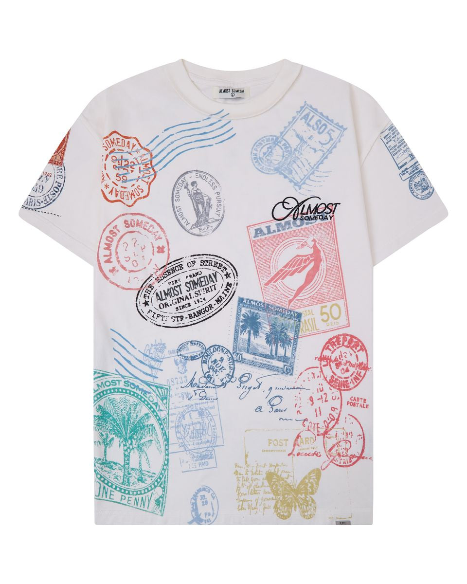 cream t-shirt with colorful stamp designs on a white background