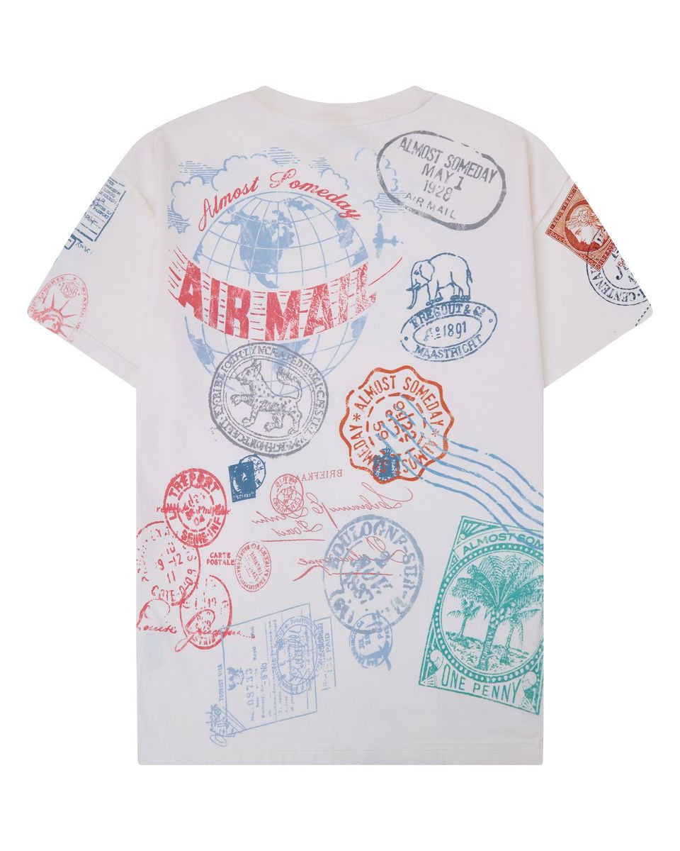 White t-shirt with colorful postage stamp designs on a white background