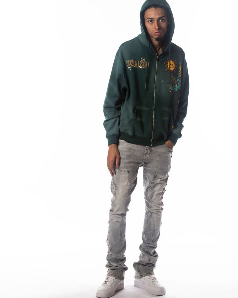 Person wearing a green hoodie with text and graphics, standing against a white background