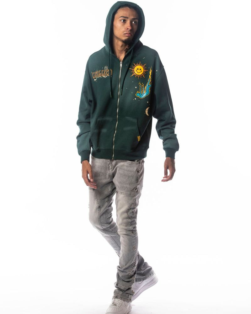 Person wearing a green hoodie with graphic designs on a white background