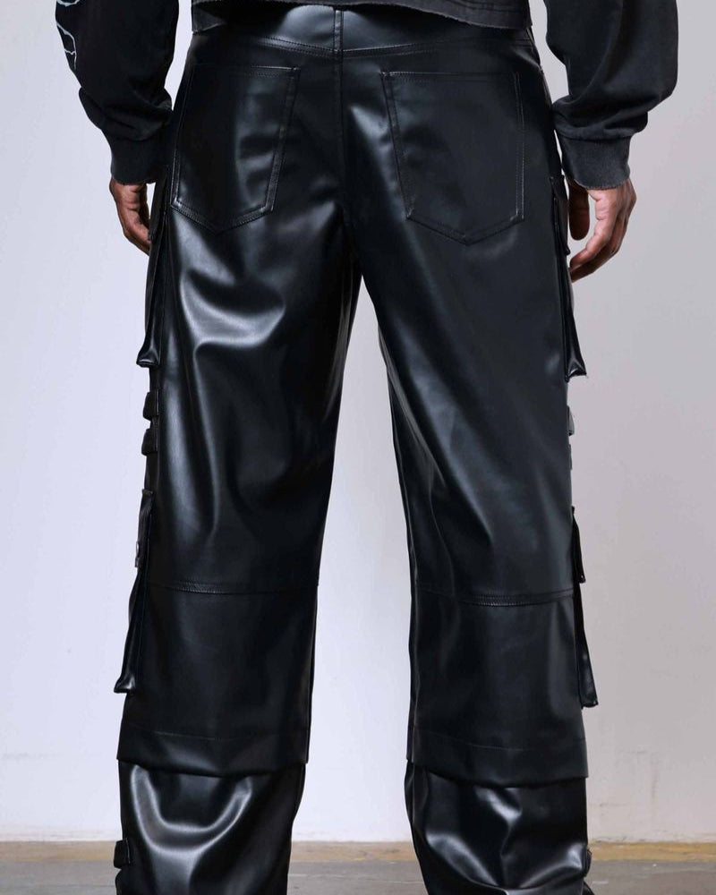 Black leather pants worn by a person against a plain background