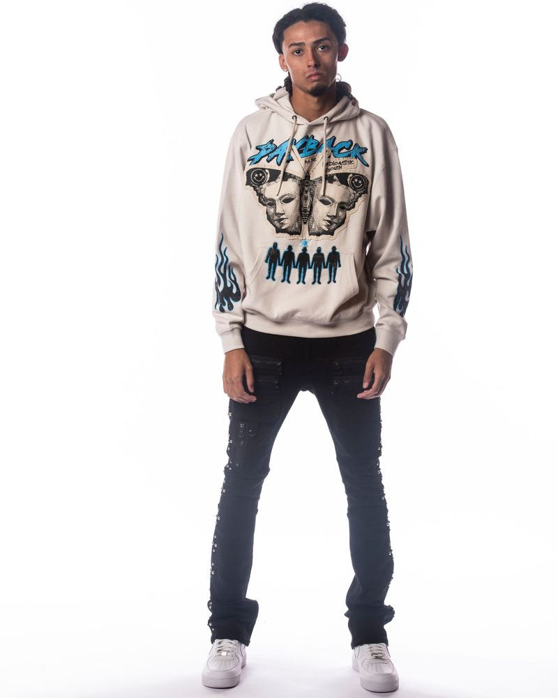 Person wearing a beige hoodie with graphic designs on a white background