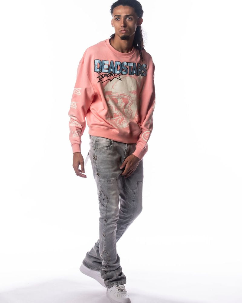 Person wearing a pink sweatshirt with graphic design and text, standing against a white background