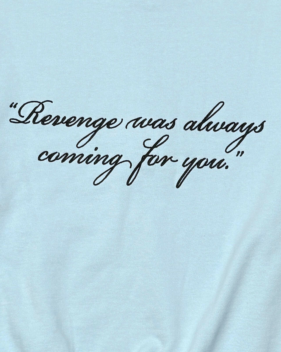 Light blue t-shirt with black text 'Revenge was always coming for you.'