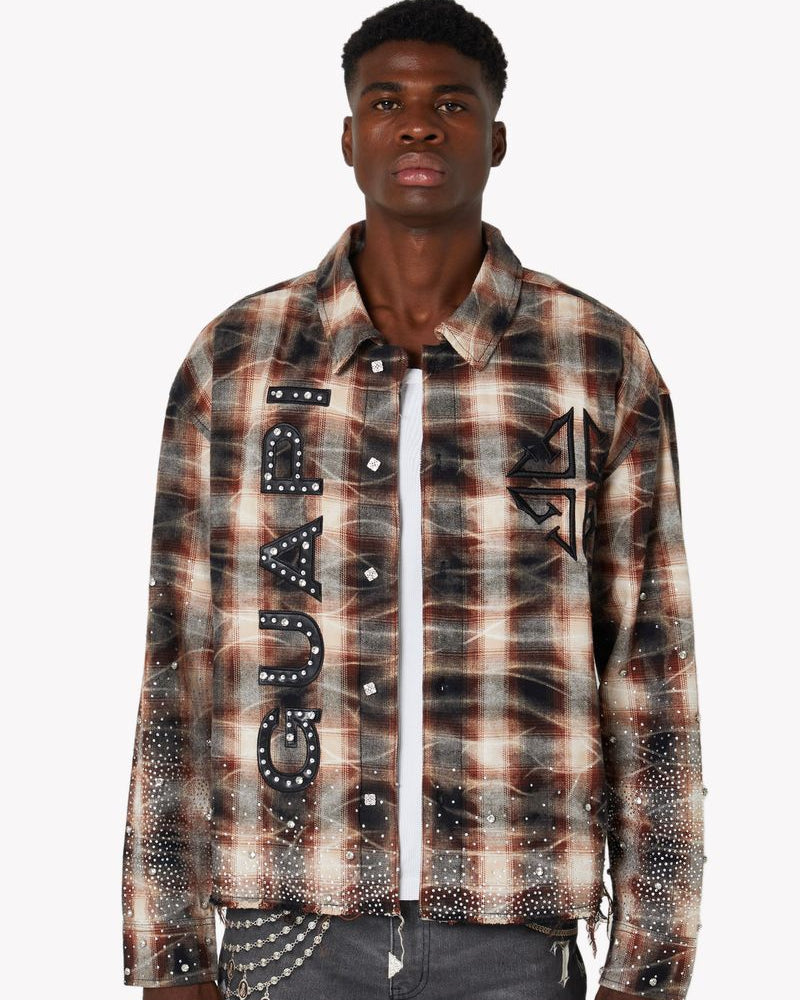 Man wearing a plaid shirt with brand logo on a white background