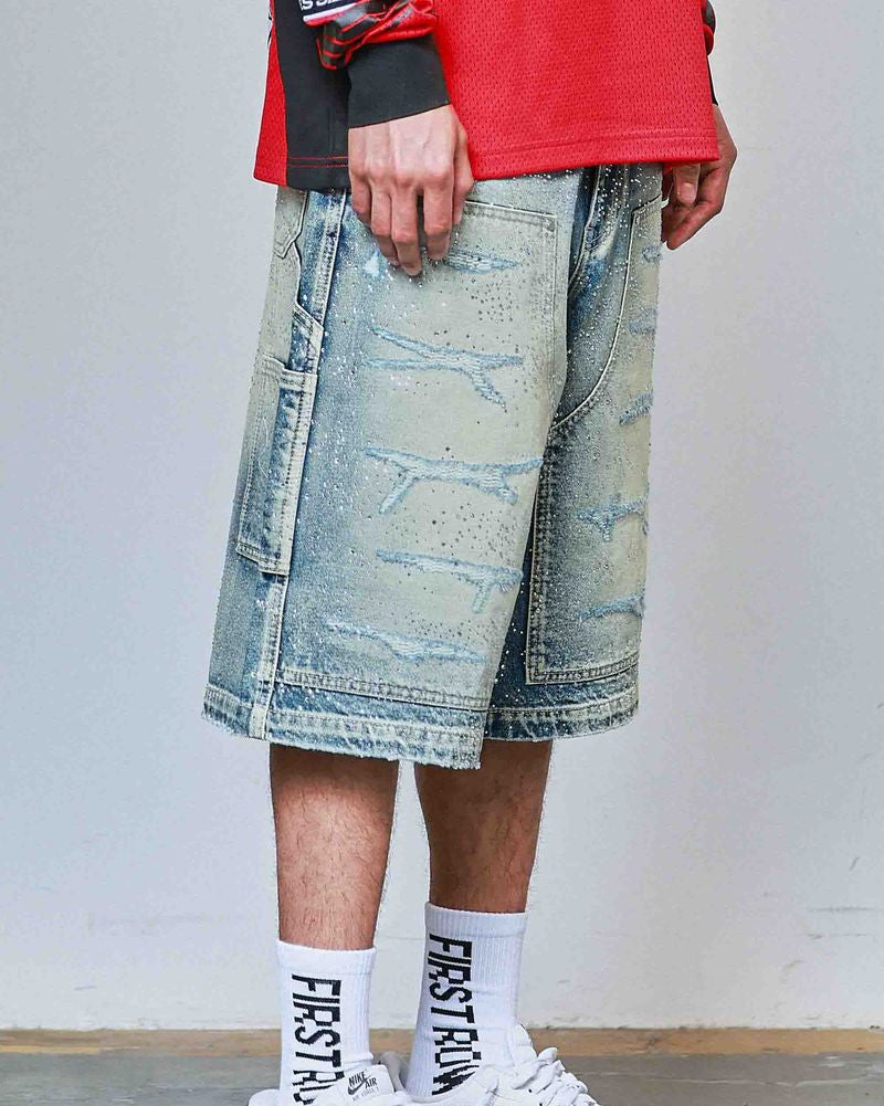 Person wearing a red jacket, denim shorts, white sneakers, and socks with text.
