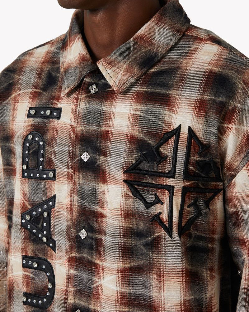 Plaid shirt with studded details and a logo on a white background