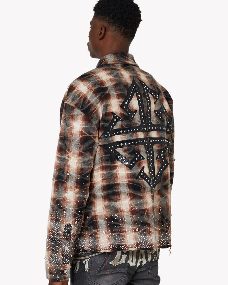 Person wearing a plaid shirt with decorative elements on the back