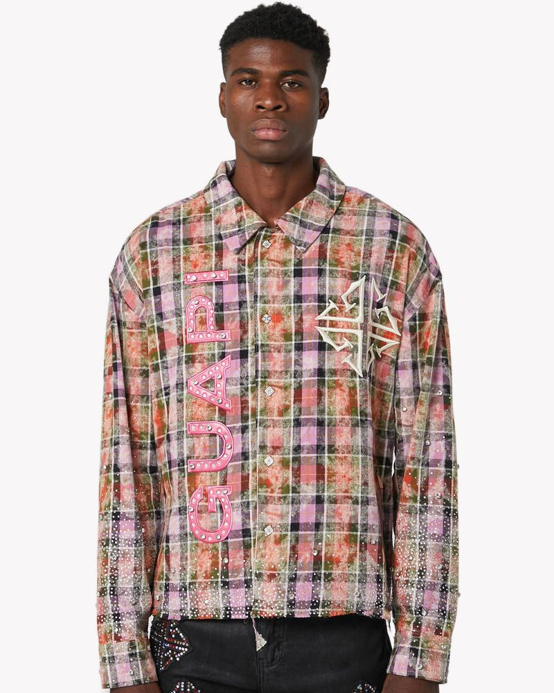 Person wearing a colorful plaid shirt with 'Gucci' branding on a white background
