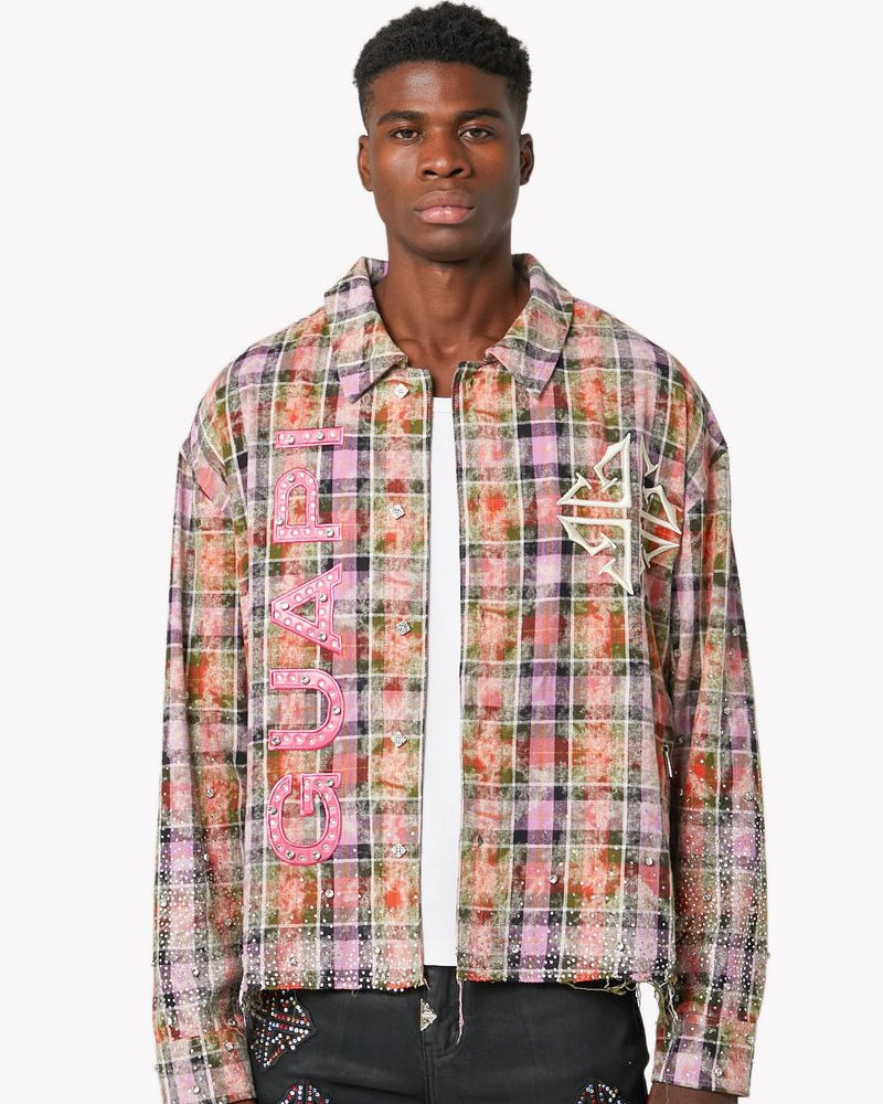 Man wearing a colorful plaid shirt with brand logo on a white background