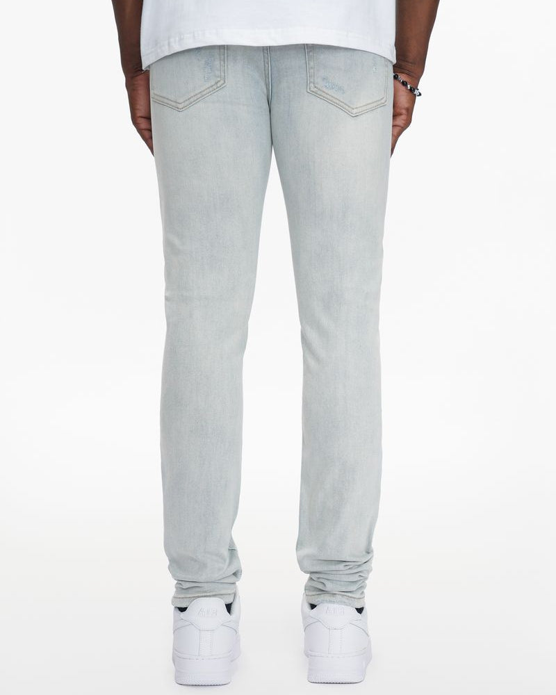 Light gray jeans worn by a person on a white background