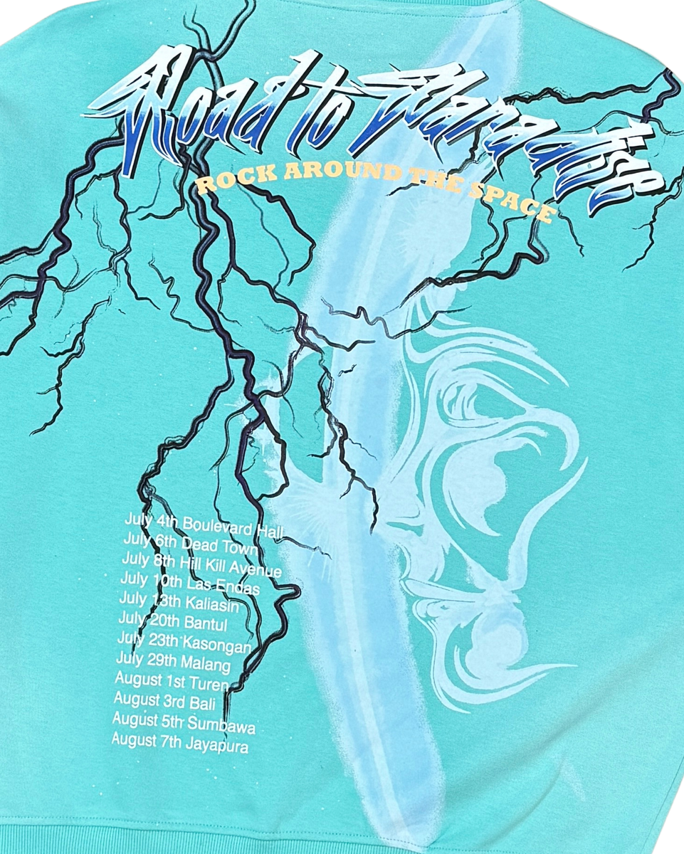 Turquoise t-shirt with graphic design and text on a white background