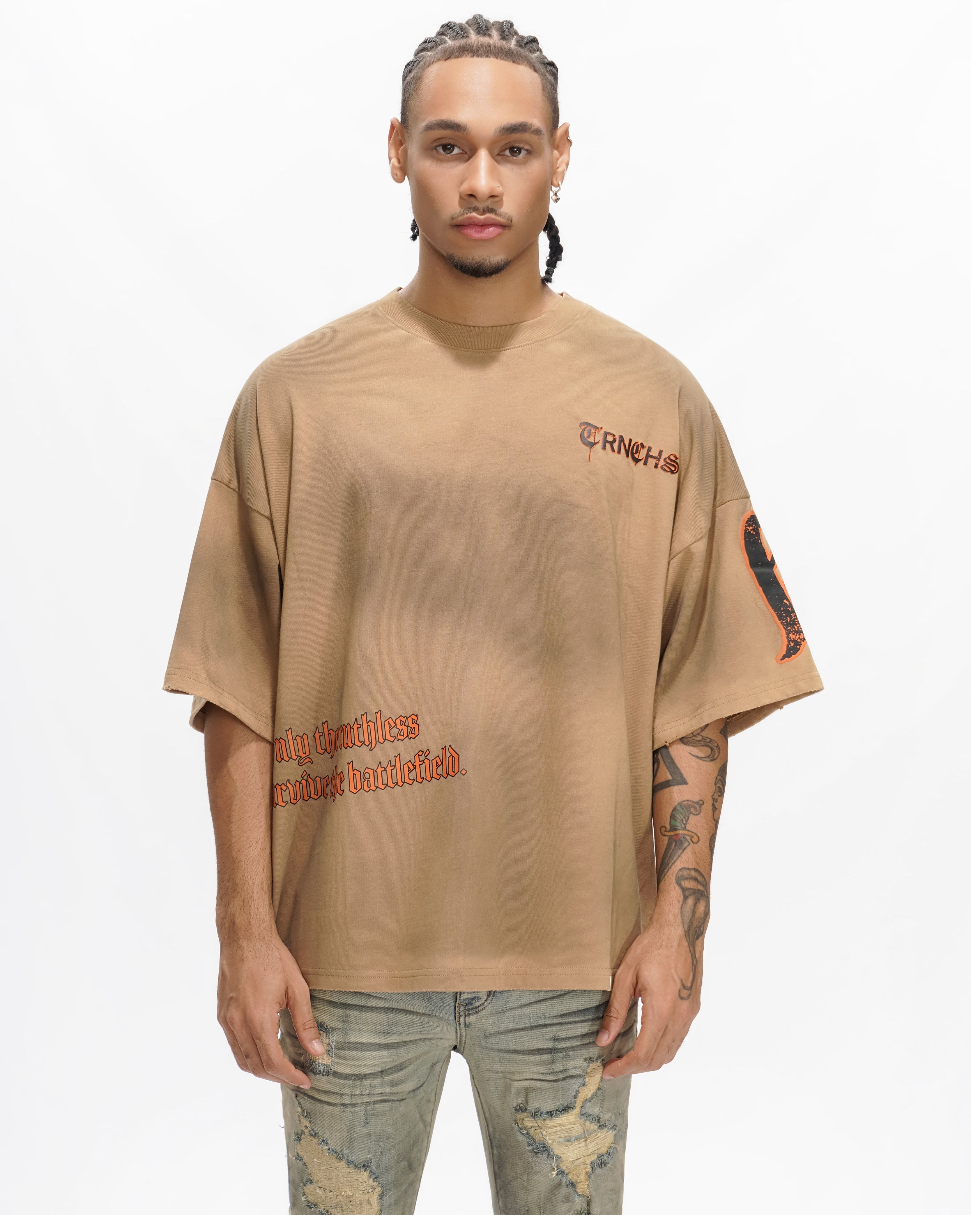 Person wearing a beige t-shirt with text on a white background