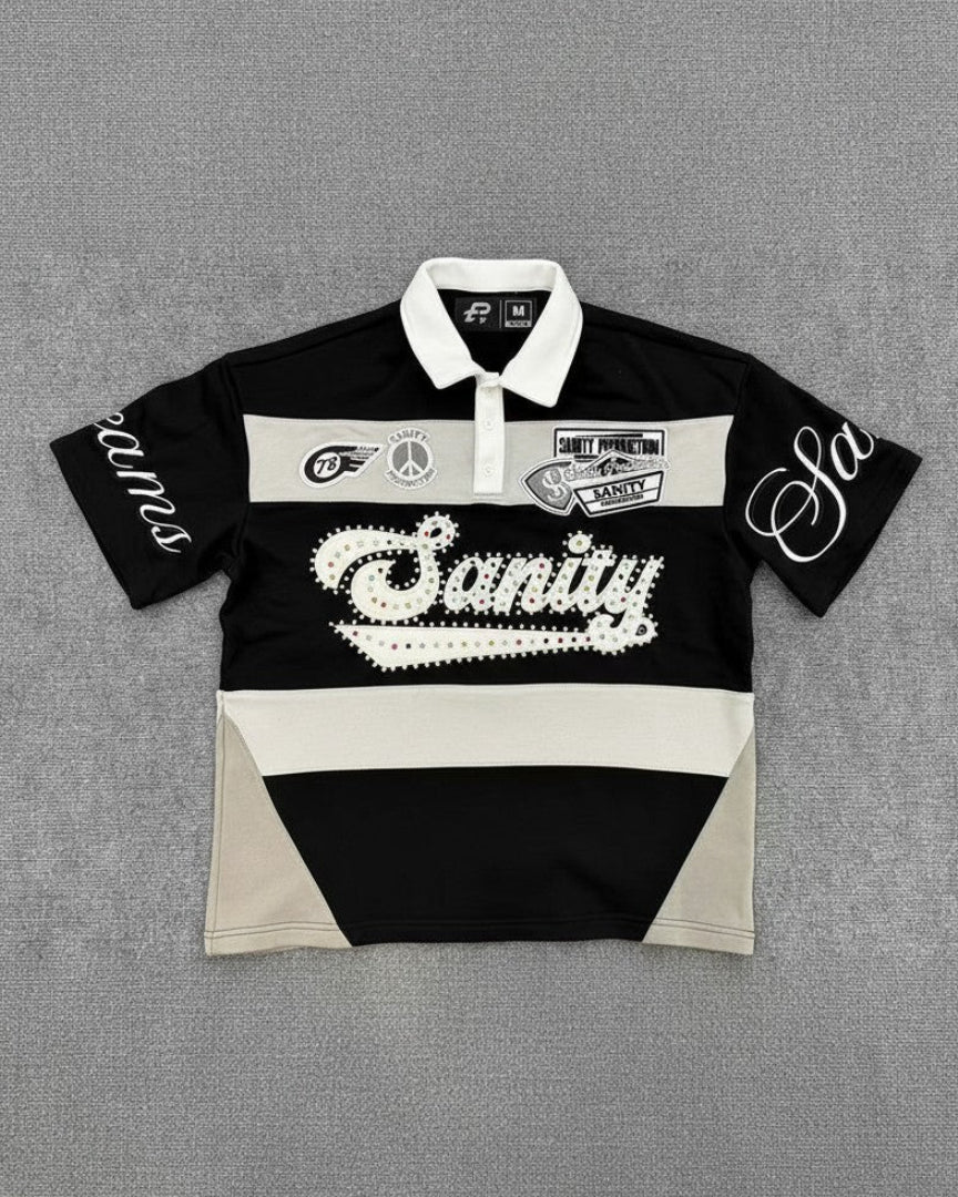 Black and white polo shirt with 'Sanity' branding on a gray background