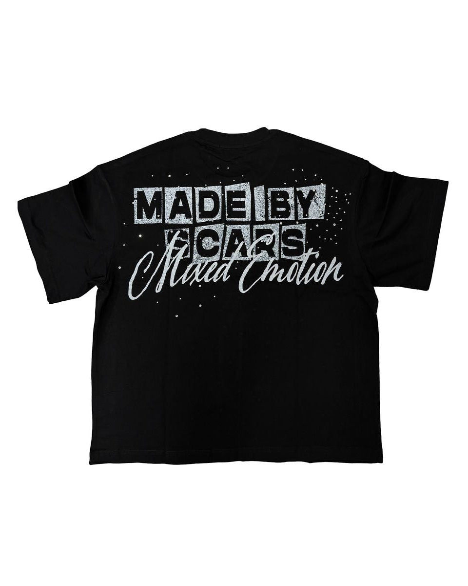 black t-shirt with rhinestone details and phrase "made by scars mixed emotions".