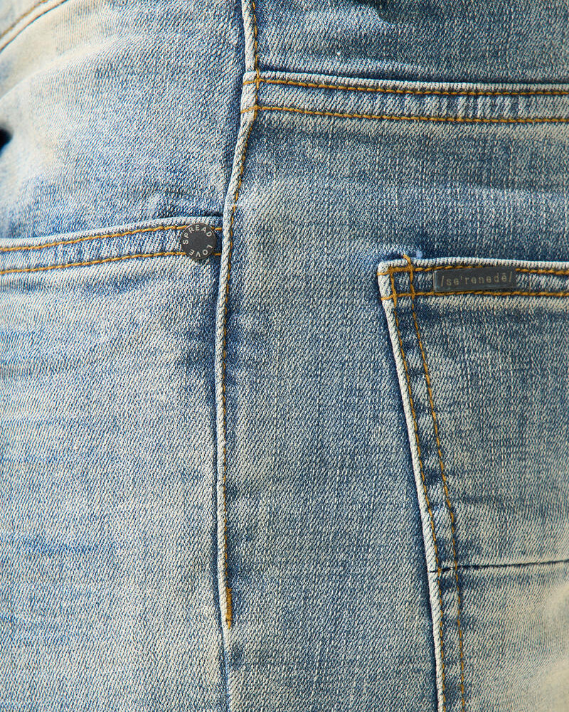 Close-up of blue denim fabric with stitching details