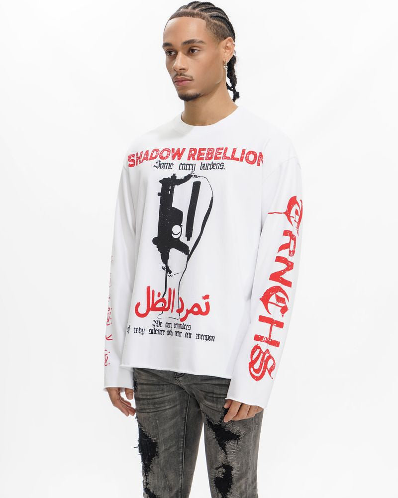 Person wearing a white long-sleeve shirt with red and black graphics and text on a white background