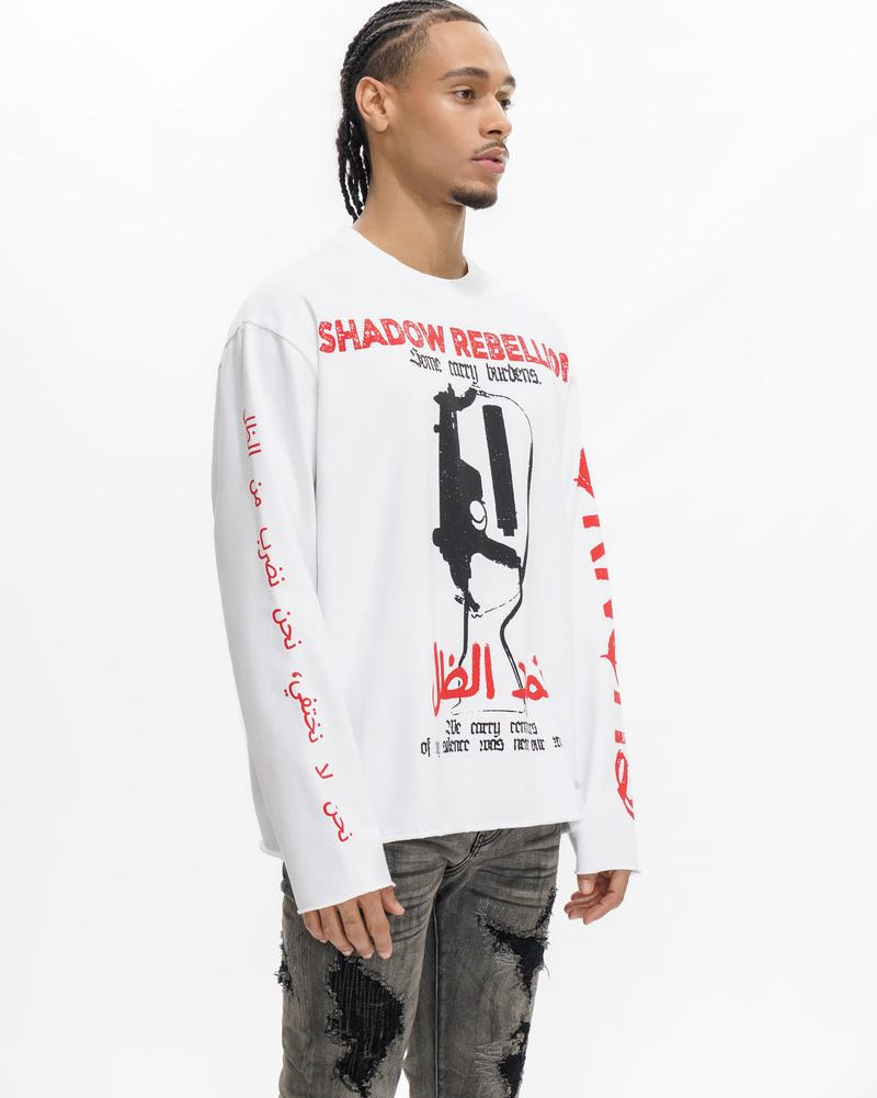 Person wearing a white long-sleeve shirt with graphic design and text on a white background